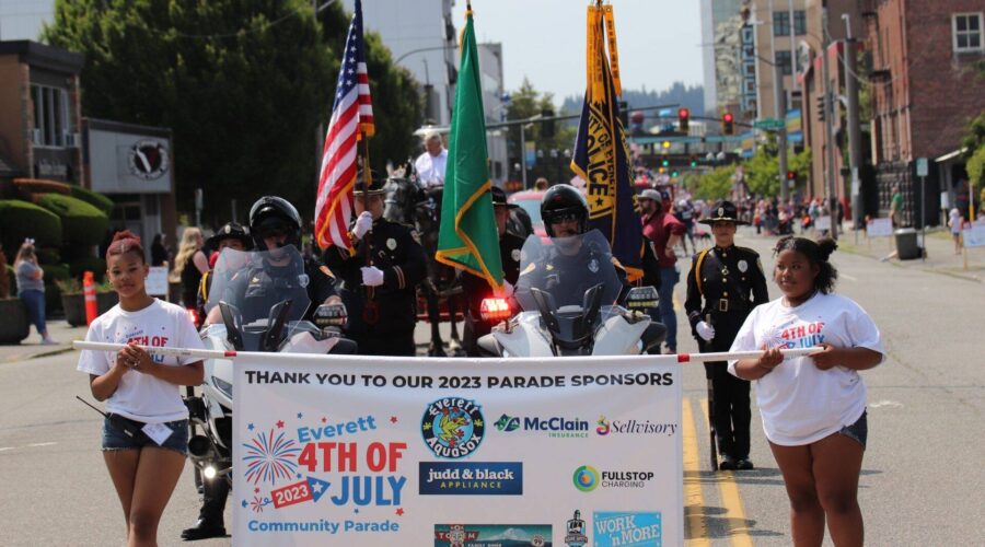 volunteers of Everett's Independence Day banner at parade